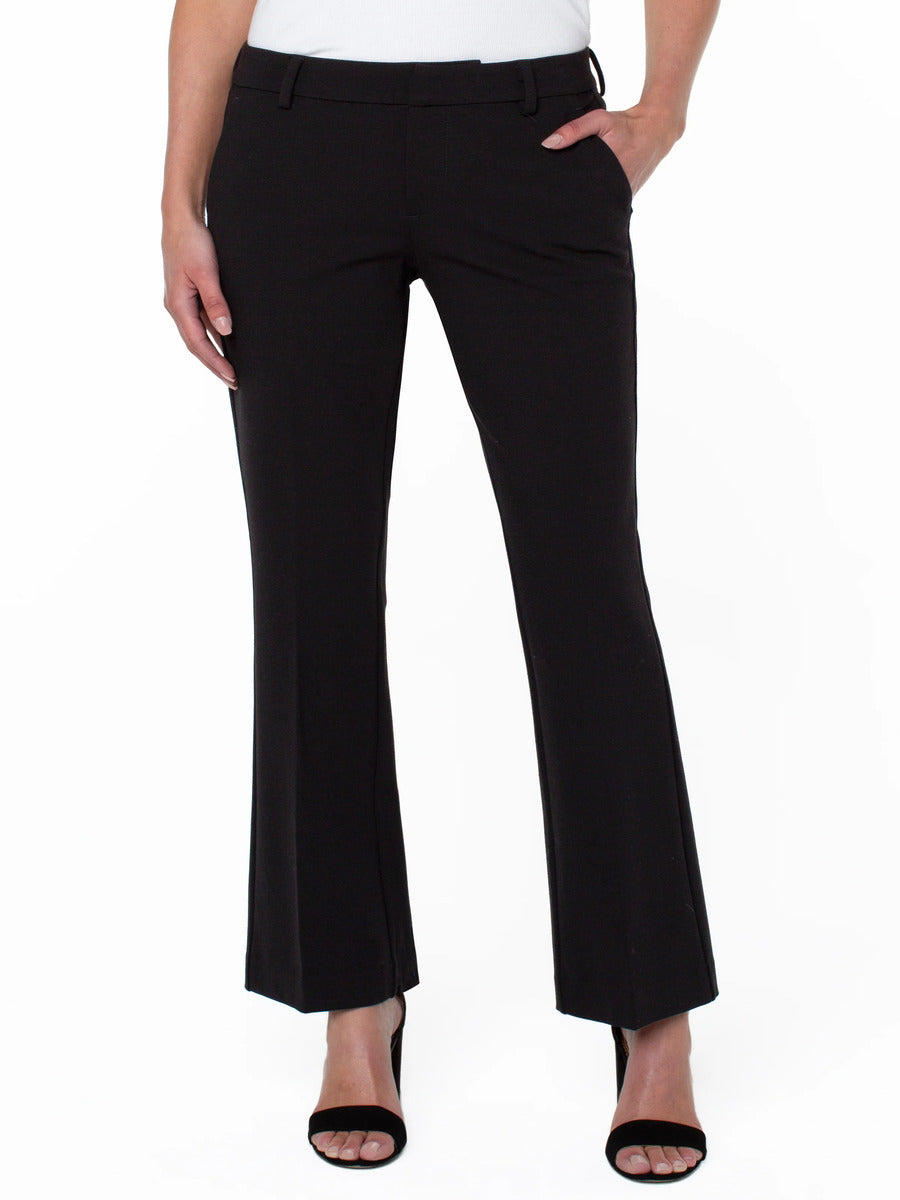 Black tailored straight-leg pants with belt loops and front pockets worn with black open-toe heels.