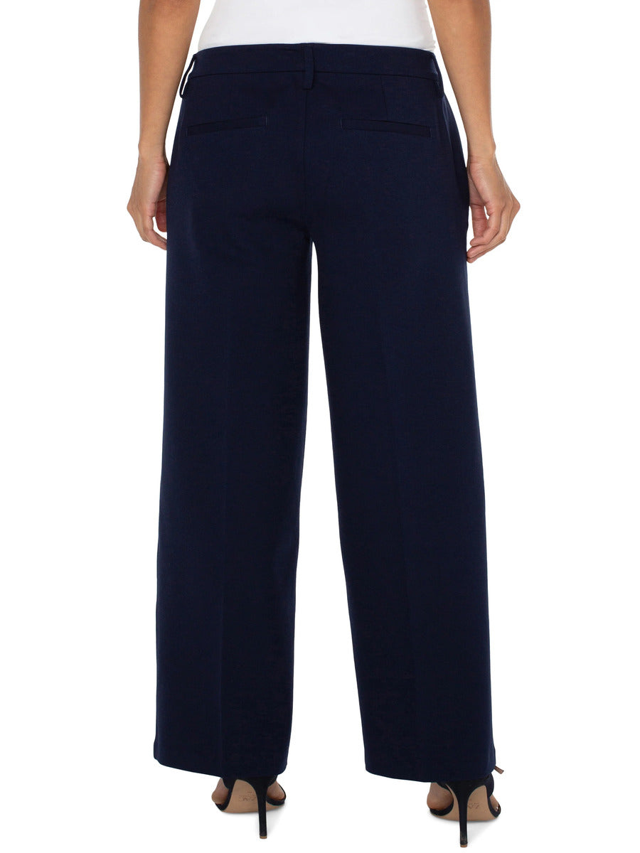 Back view of navy Liverpool Kelsey 31” Wide Leg Trouser styled with heels for a polished look.