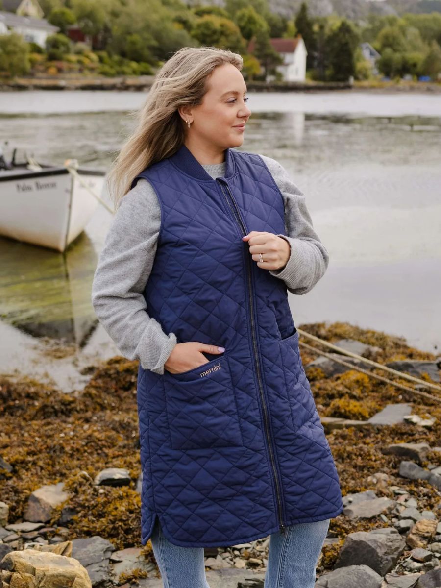 Mernini Quilted Double Pocket Vest by MERNINI/ROCK RAIN INC in navy blue quilted outerwear near water and rocks
