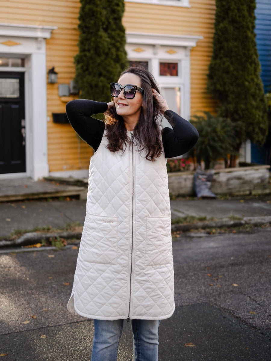 Mernini Quilted Double Pocket Vest in cream outerwear by MERNINI/ROCK RAIN INC styled with casual black sweater and jeans