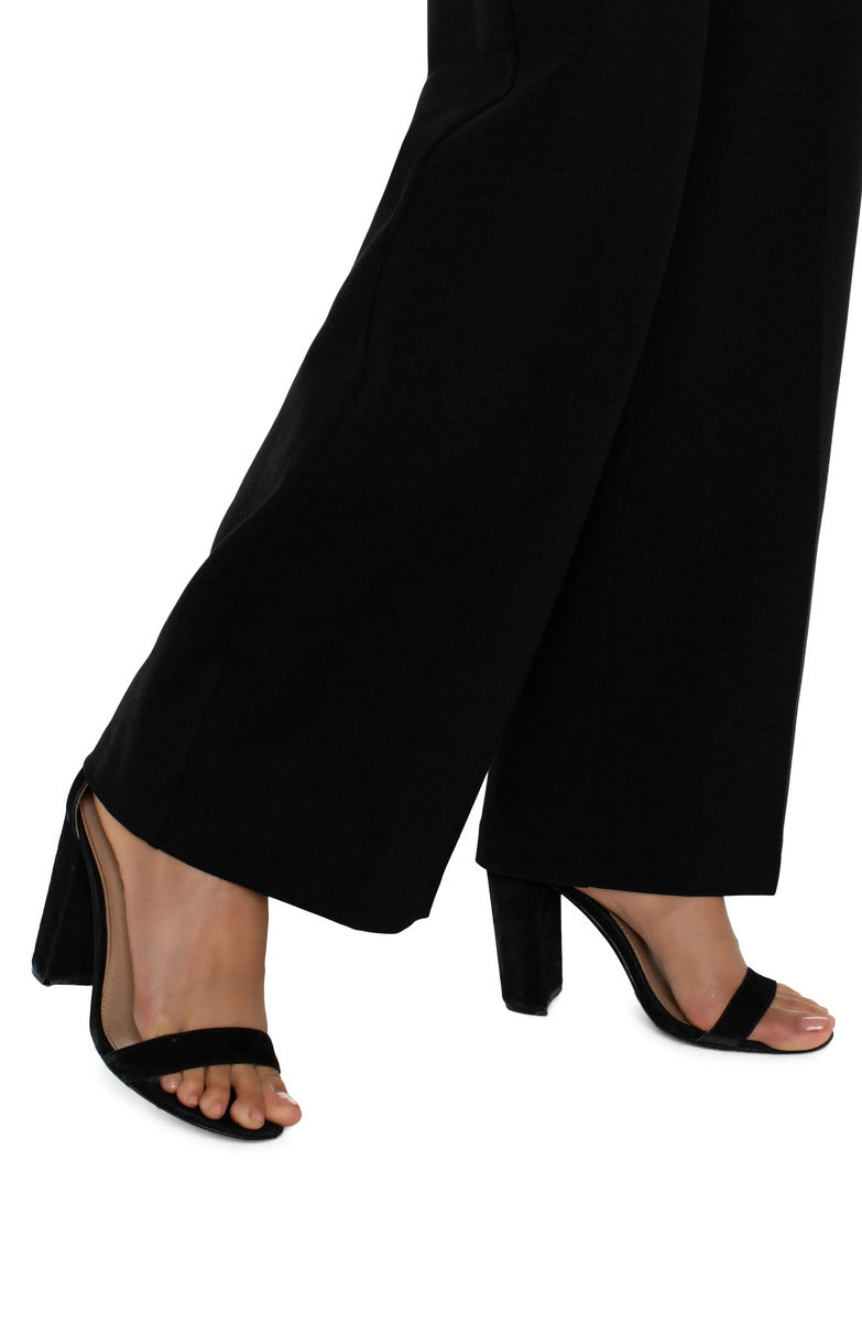 Close-up of black Liverpool Kelsey Wide Leg Trouser paired with black open-toe block heel sandals in a stylish look