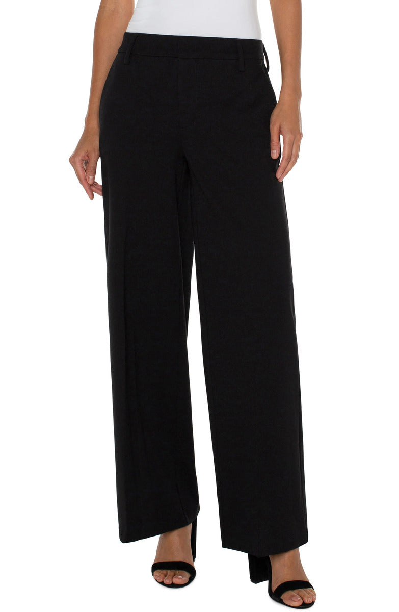 Black wide leg trouser from Liverpool Kelsey Wide Leg Trouser collection styled with open-toe heels and white top.