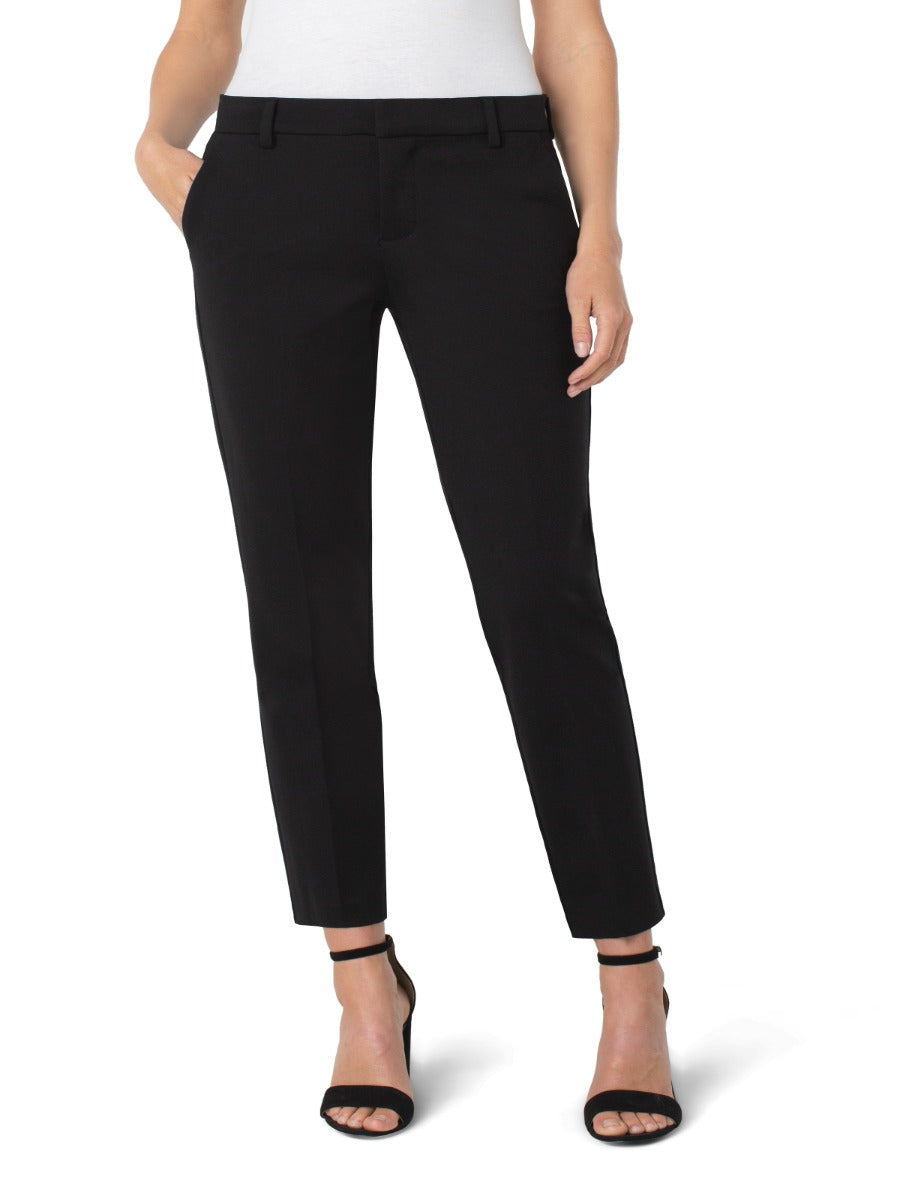 Liverpool Petite Kelsey 27” Solid Pant in black by Liverpool shown with black ankle-strap heels and white top.