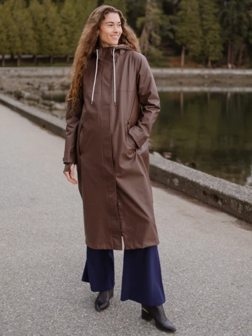 Mernini 48” Length Waterproof Raincoat in brown by MERNINI/ROCK RAIN INC, styled as outerwear for wet weather.