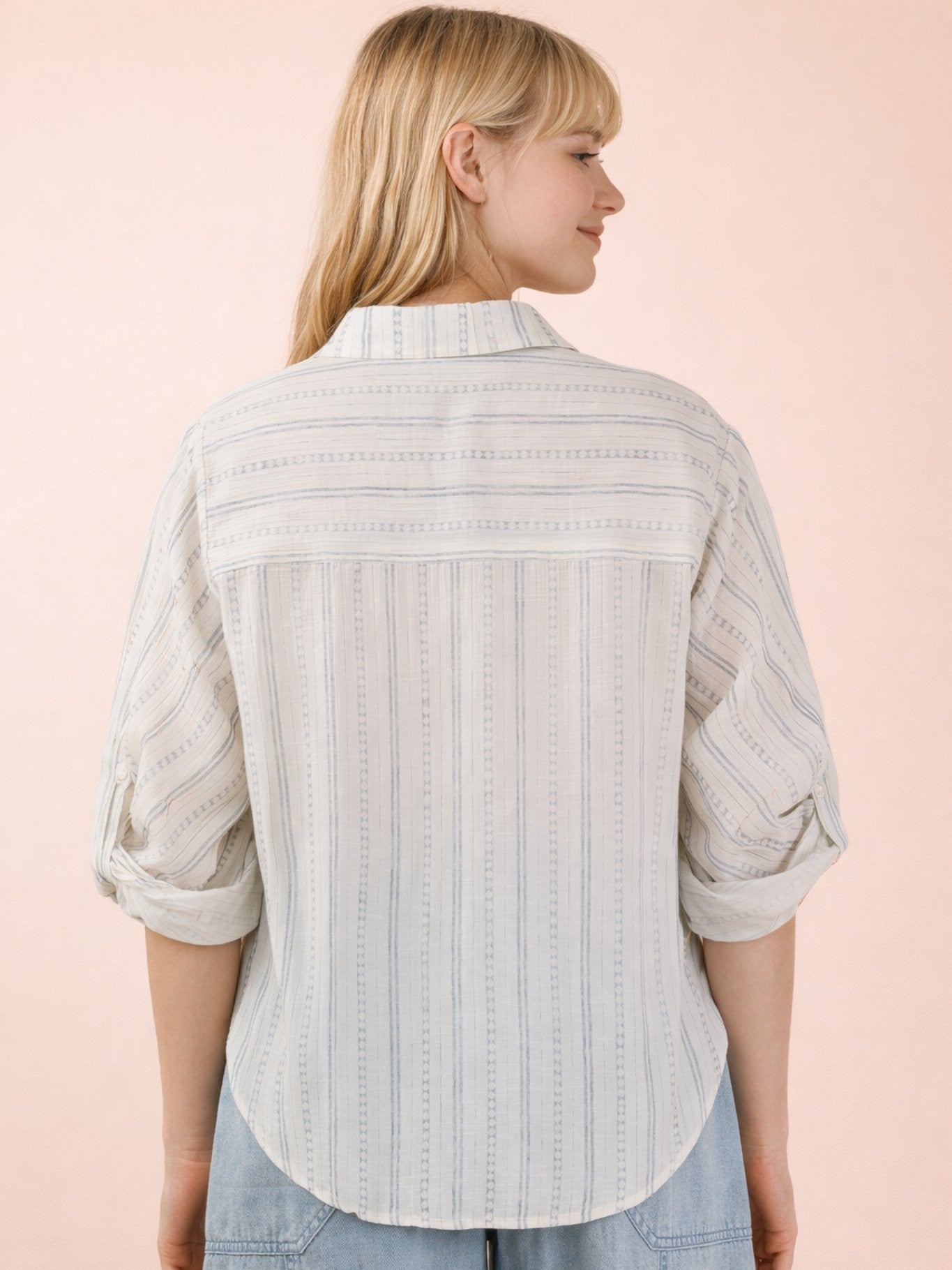 Back view of Very J Roll Sleeve Stripe Lightweight Blouse in white with subtle vertical stripes and rolled sleeves