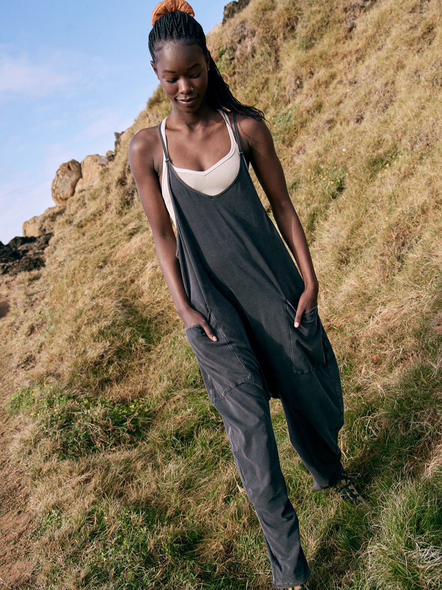 Free People Hot Shot Onesie in black, relaxed fit with pockets, styled outdoors by Free People.