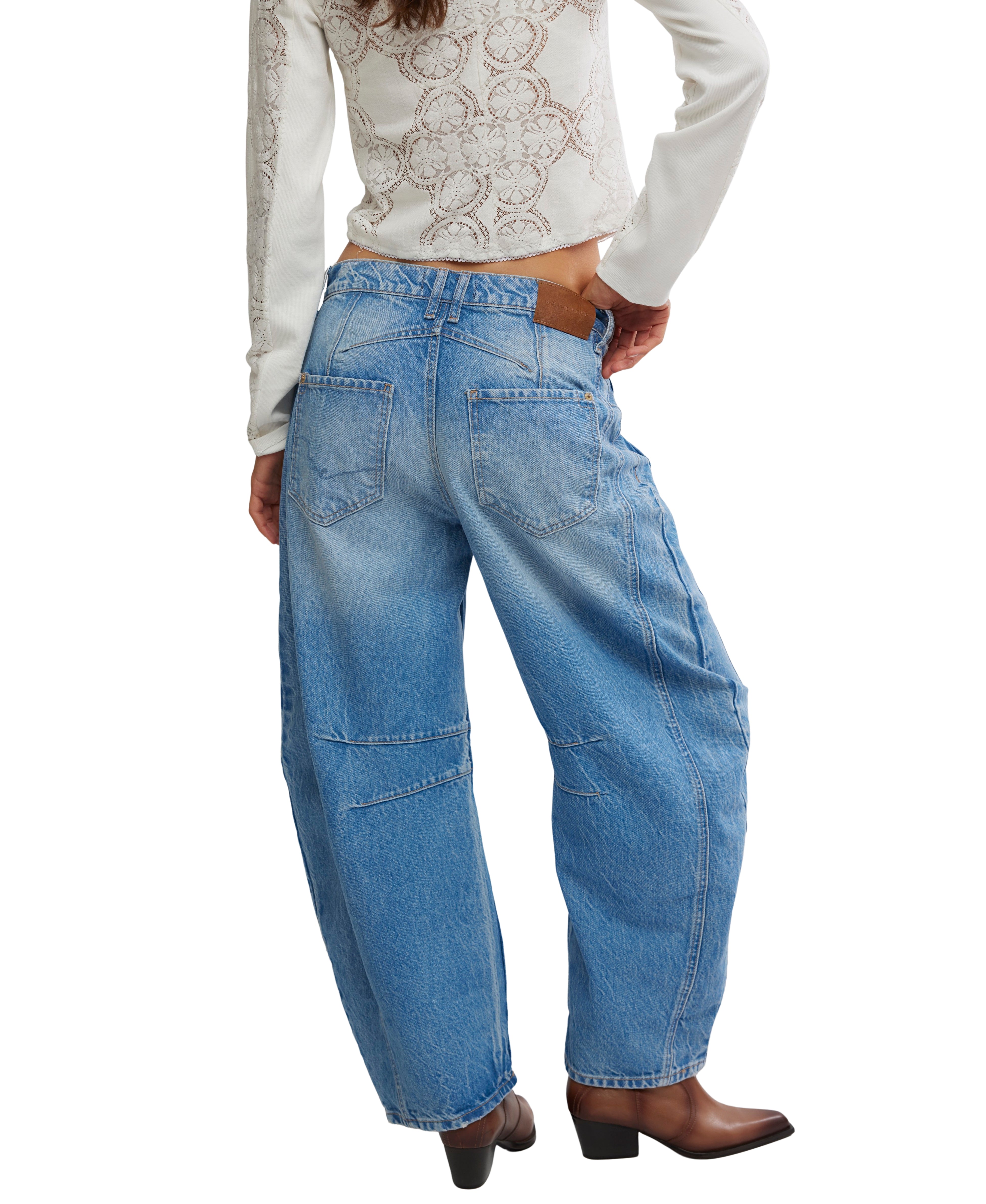 Back view of Free People Good Luck Maker Barrel Denim Jeans styled with a white long-sleeve top and brown boots