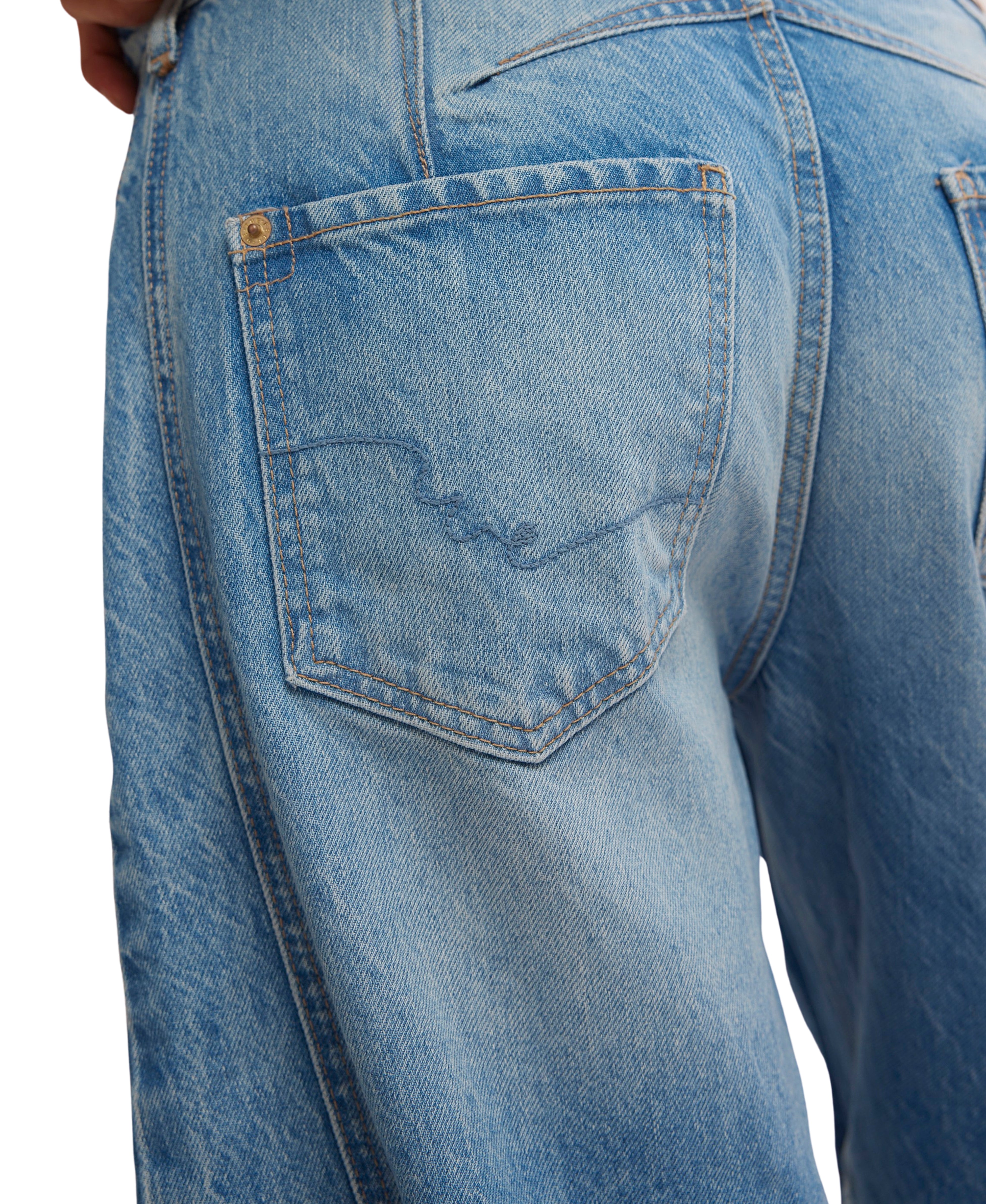 Close-up of light blue denim back pocket detail on Free People Good Luck Maker Barrel Denim Jeans by Free People