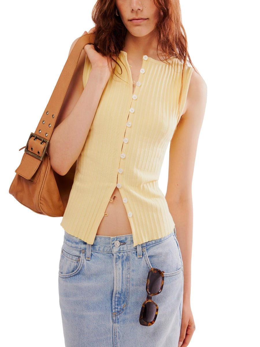 Free People Tilly Button Front Vest in soft yellow ribbed fabric, styled with denim skirt and tan leather bag.