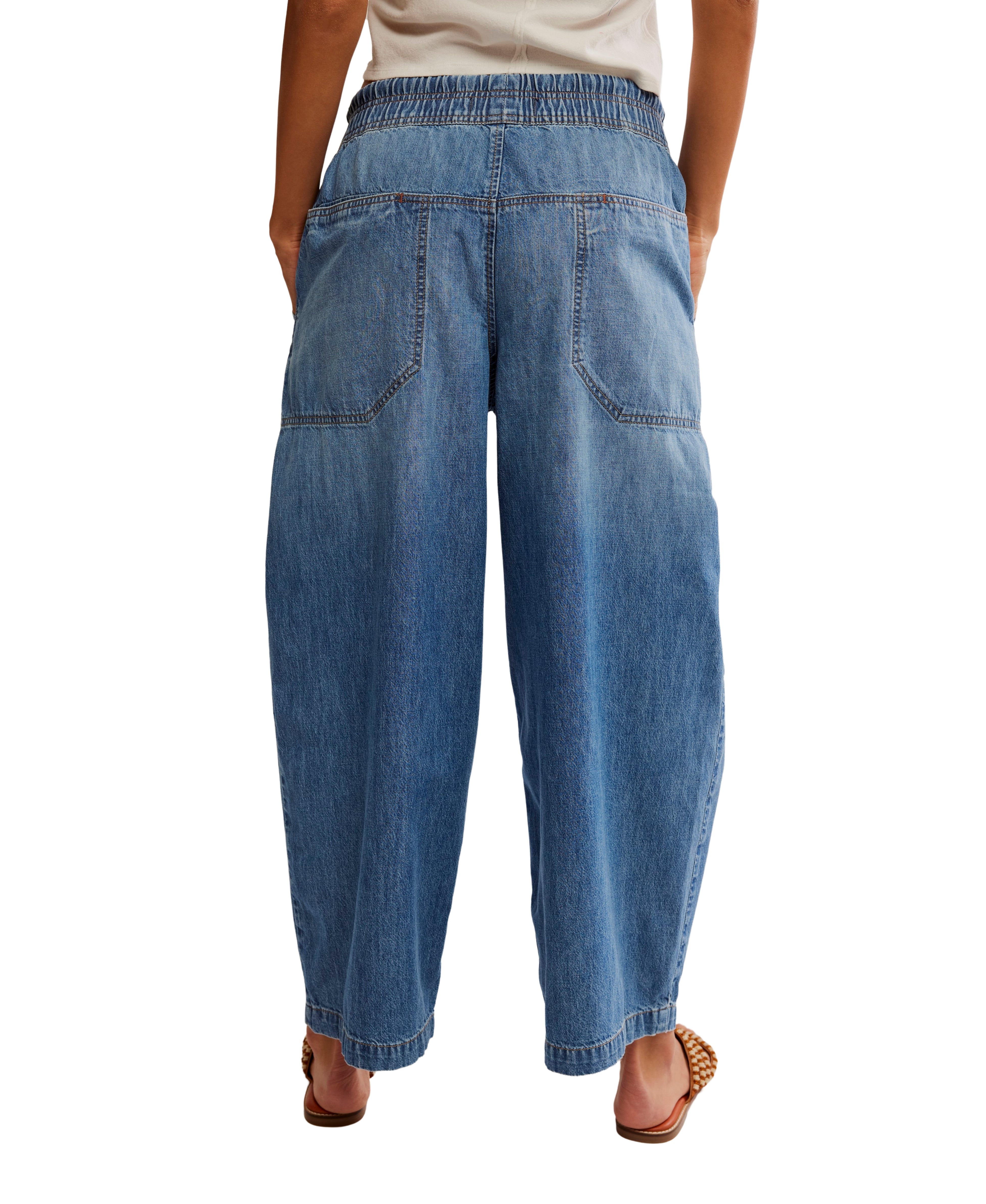 Free People Easy Peasy Pull-On Drawstring Denim Pants in light blue denim with large back pockets and elastic waistband.