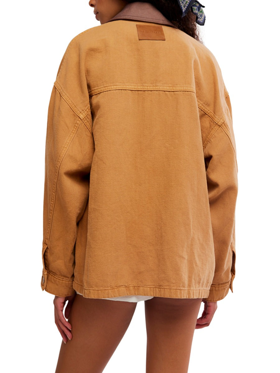 Back view of free people lemon meerkat denim jacket in cognac brown outerwear on model with scarf accessory
