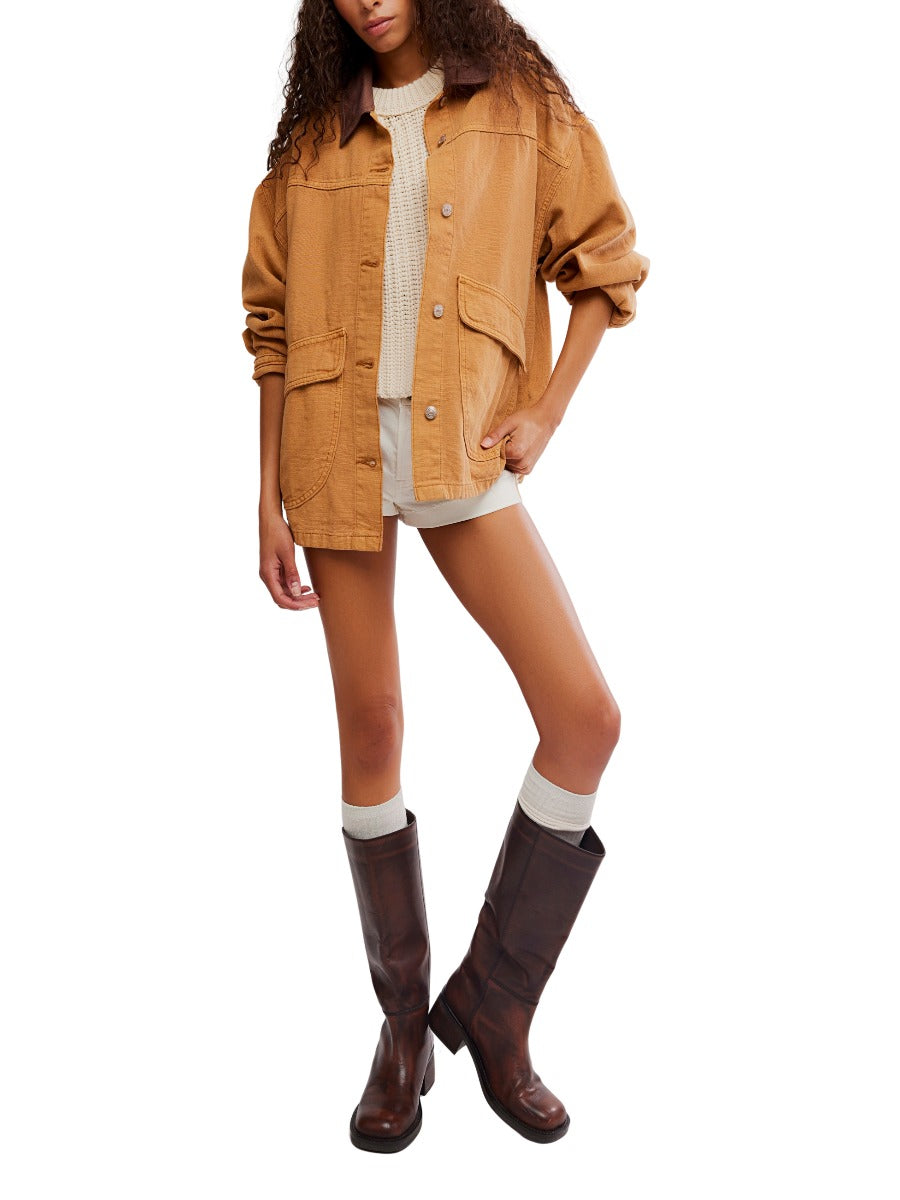Free People Lemon Meerkat Denim Jacket in cognac brown paired with shorts and tall brown boots by Free People.