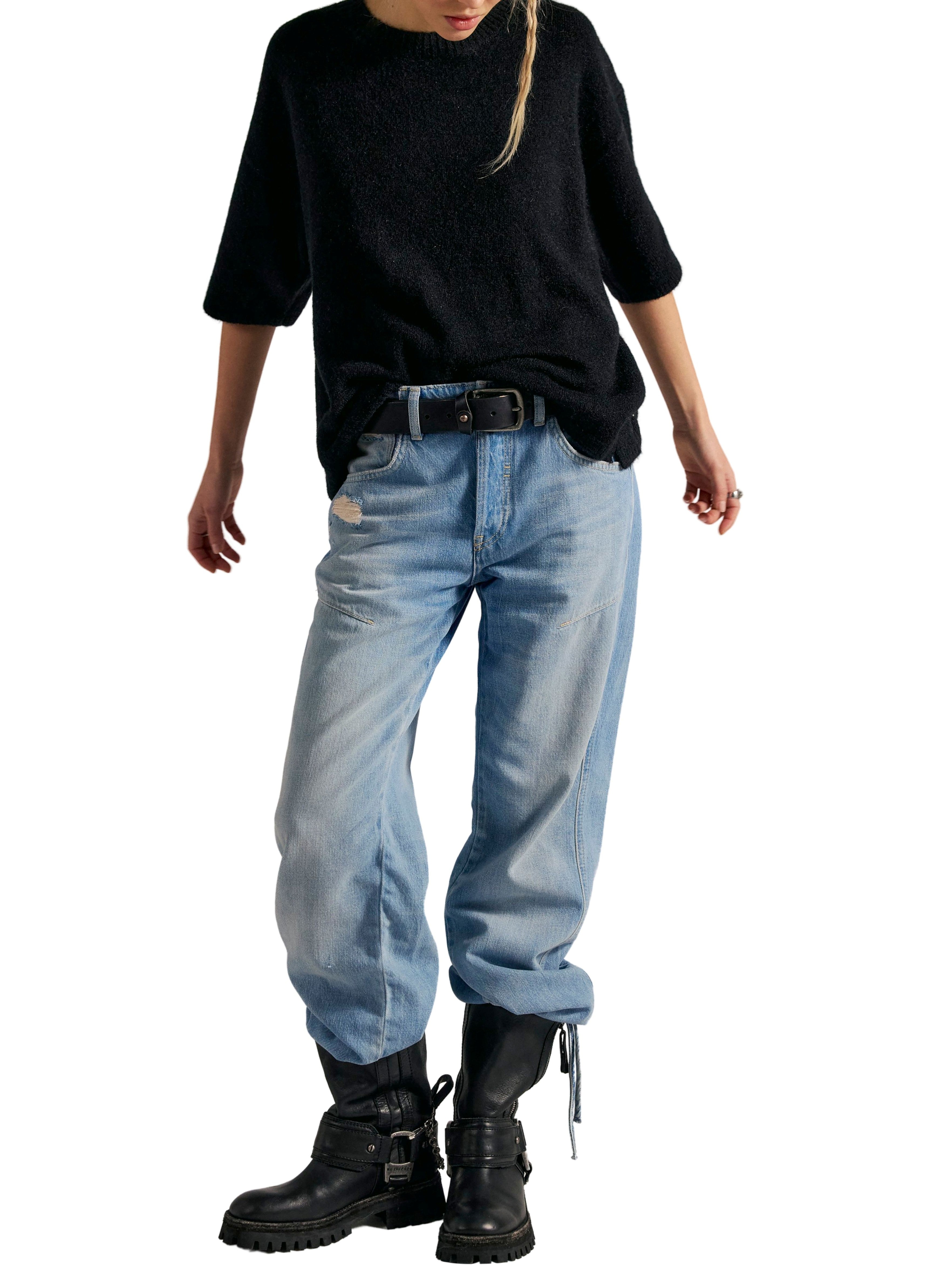 Black oversized sweater paired with light blue distressed jeans and black buckle combat boots.
