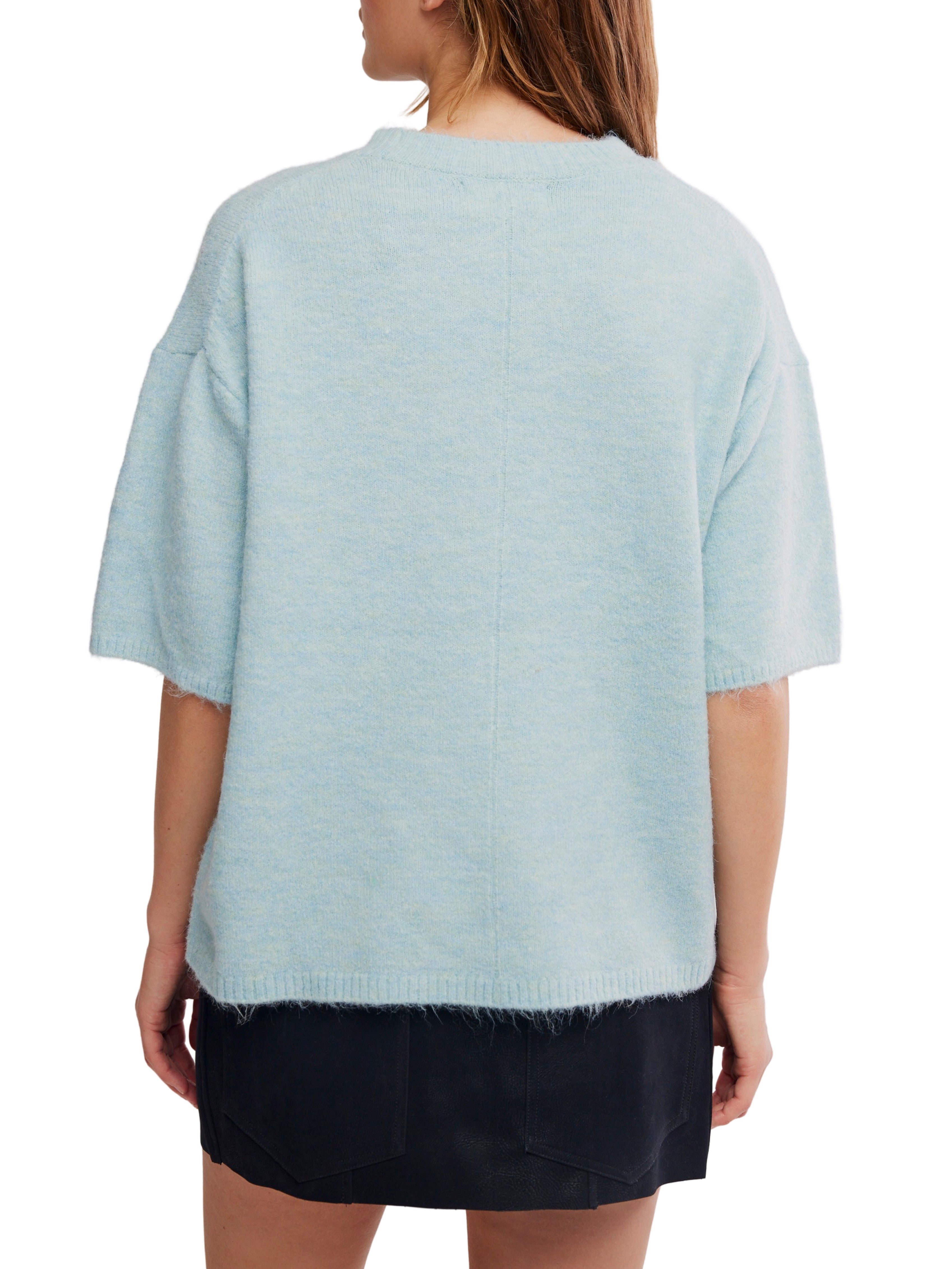 Light blue short-sleeve knit sweater with a soft texture, shown from the back paired with a black skirt.
