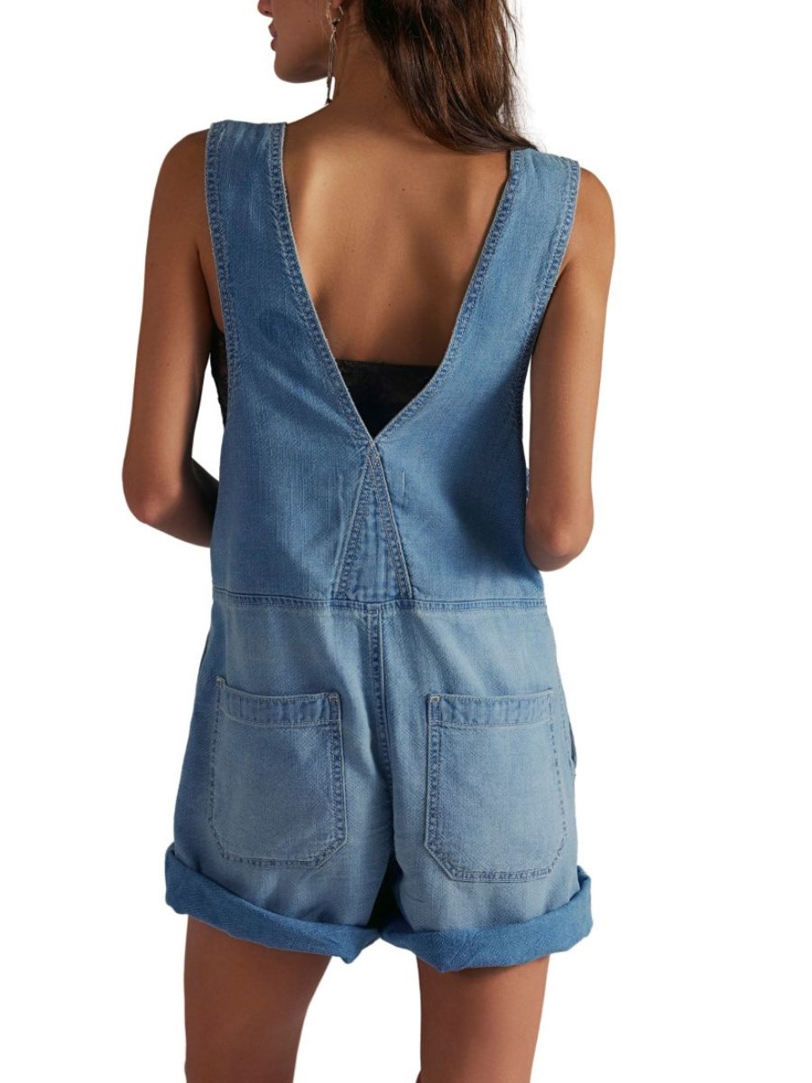 Back view of denim shortall with deep V-back and rolled shorts in Free People Jude Zip Front Denim Shortall by Free People