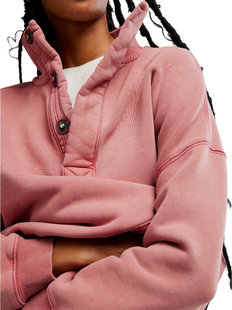Close-up of a rose pink Free People Timeless Snap Pullover sweater with snap button collar and ribbed cuffs