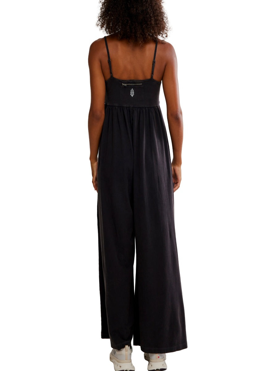 Back view of black Free People Hot Shot Strappy Onesie with adjustable straps and wide-leg pants by Free People