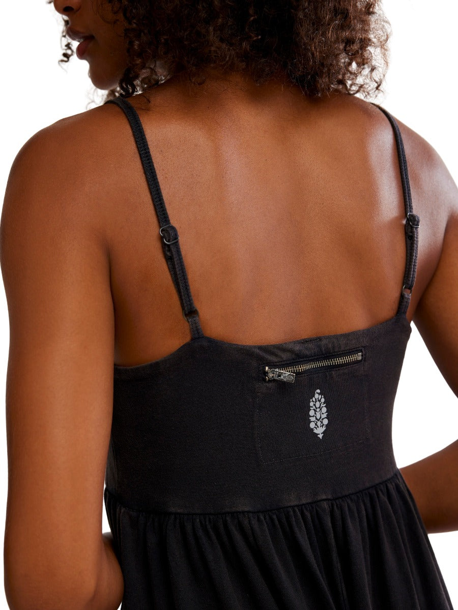 Back view of Free People Hot Shot Strappy Onesie in black with adjustable straps and small zipper pocket detail.
