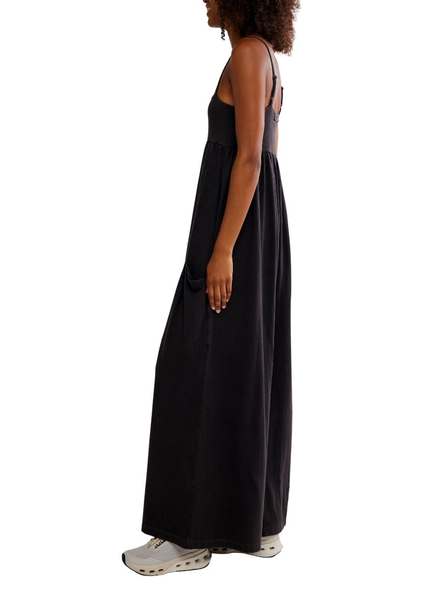 Side view of a black Free People Hot Shot Strappy Onesie with adjustable straps and relaxed fit by Free People