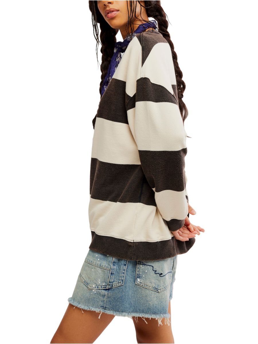 Black and cream striped sweater paired with a distressed denim skirt and patterned scarf