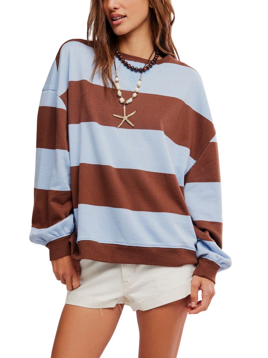 Free People Classic Wide Stripe Crewneck Sweater in periwinkle and brown, styled with layered necklaces and white shorts.