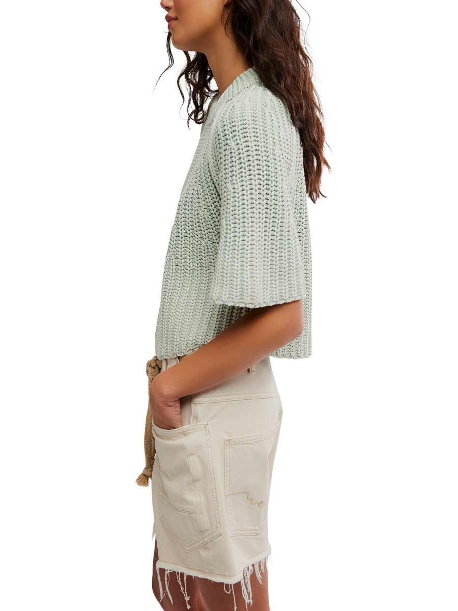 Side view of light green Free People Amy Washed Half Sleeve Crew Sweater styled with a casual skirt by Free People