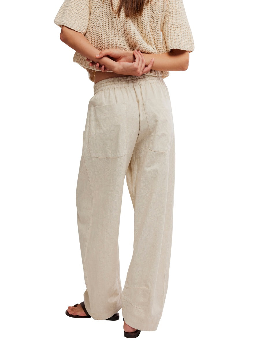 Back view of cream-colored Free People Chambers Laid-Back Solid Pant paired with knit top and sandals from Free People