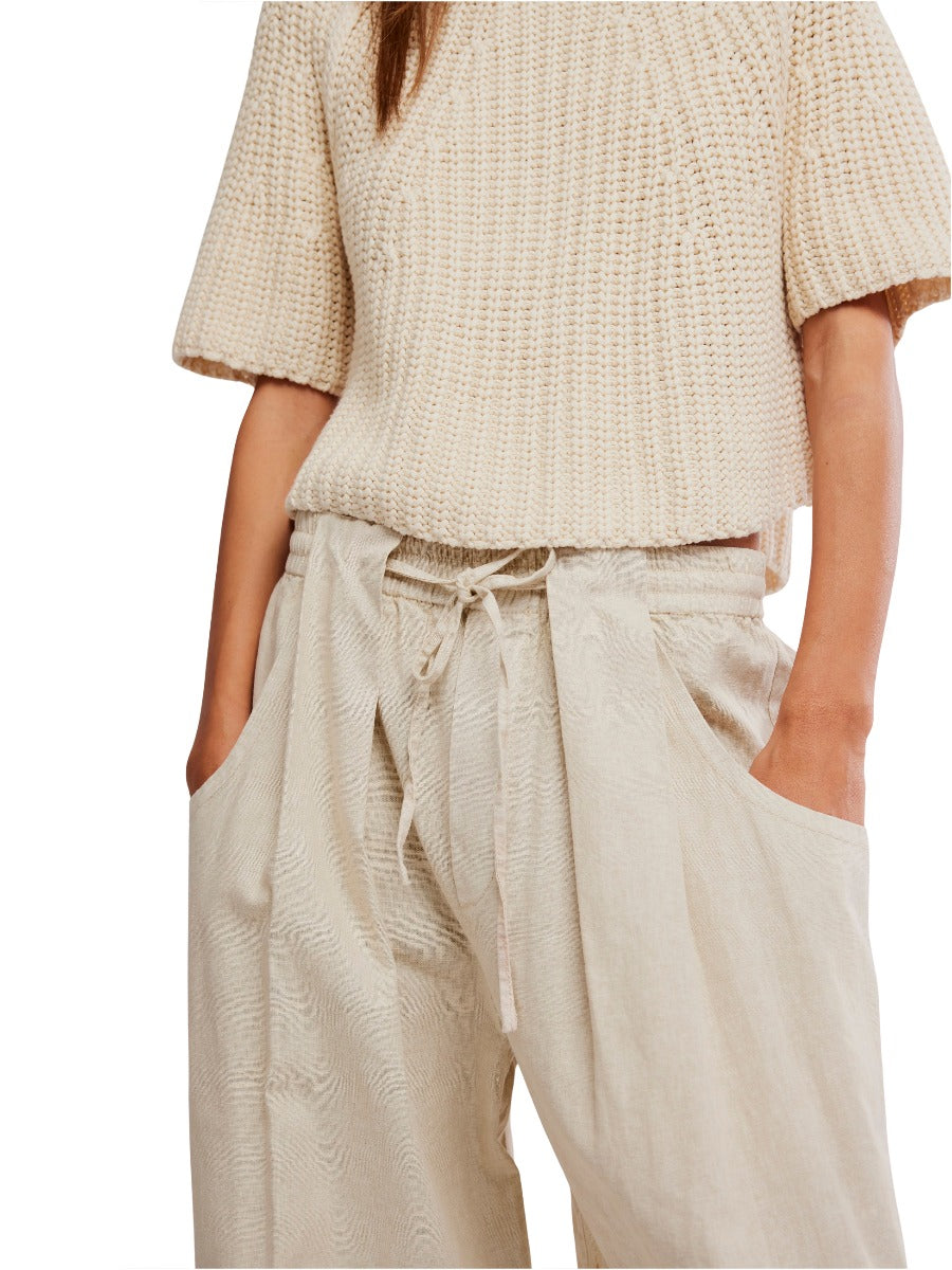Free People Chambers Laid-Back Solid Pant in light beige with drawstring waist, styled with a textured short-sleeve sweater