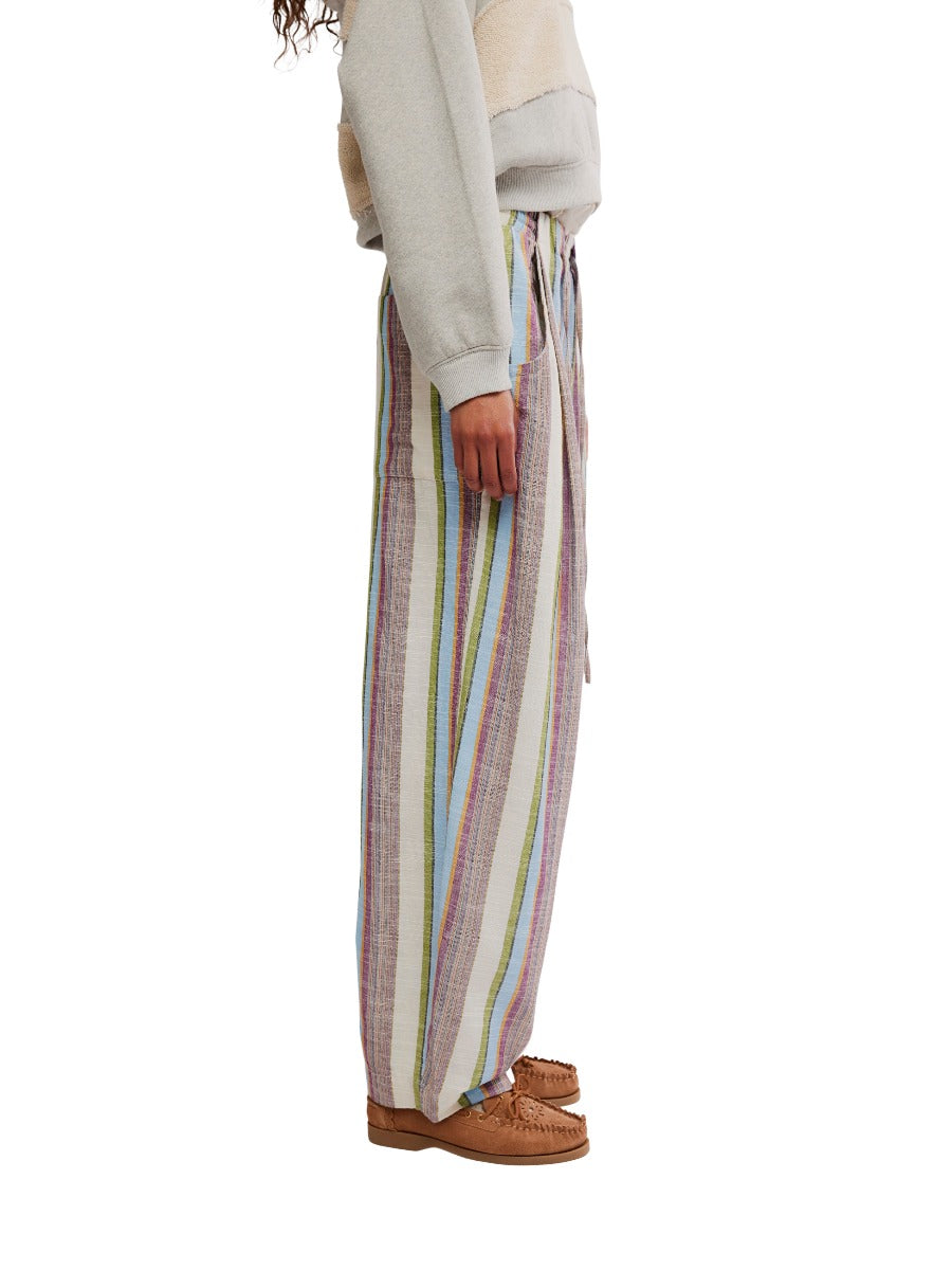 Free People Chambers Laid-Back Stripe Pant in pastel vertical stripes paired with moccasin-style shoes by Free People.