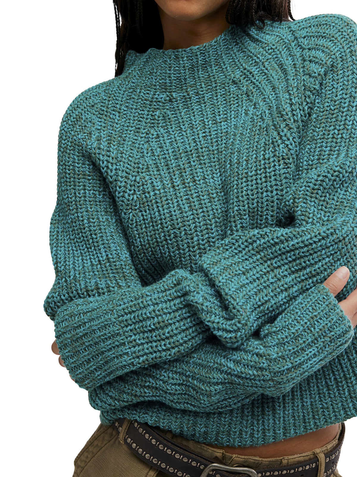 Close-up of a teal textured knit sweater with ribbed cuffs and a high neckline