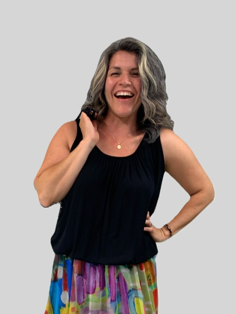 Black Miracle Bubble Hem Sleeveless Relaxed Fit Top by Plum Loco styled with a colorful patterned skirt and necklace