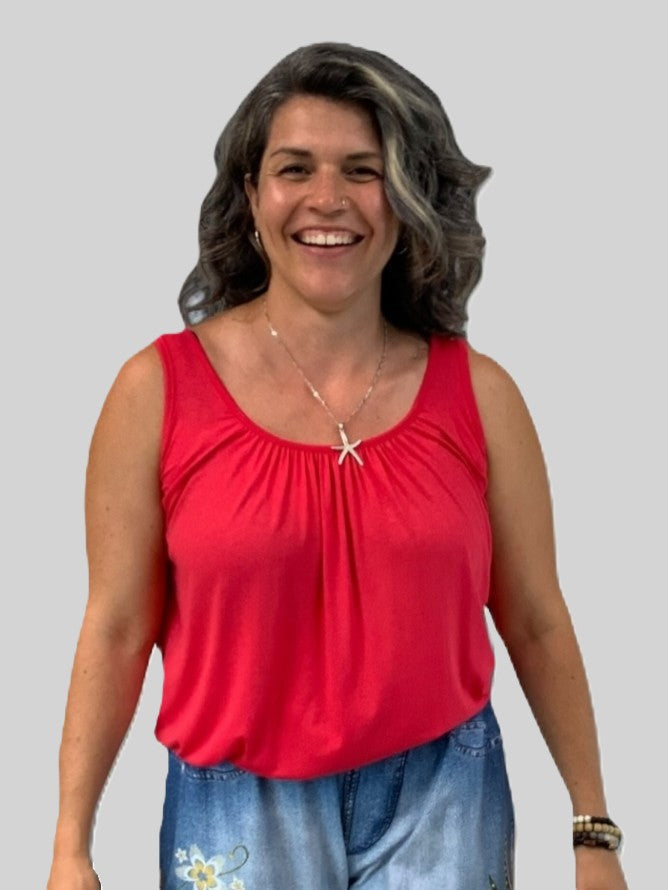Miracle Bubble Hem Sleeveless Relaxed Fit Top in coral red by Plum Loco, paired with blue floral denim shorts.