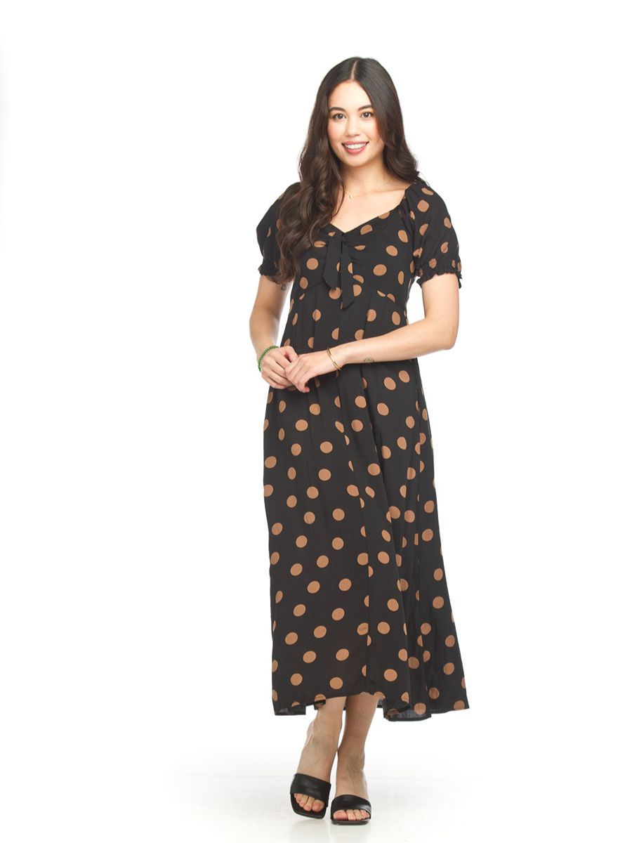 Black midi dress with brown polka dots, short puff sleeves, V-neckline, and black open-toe heels.