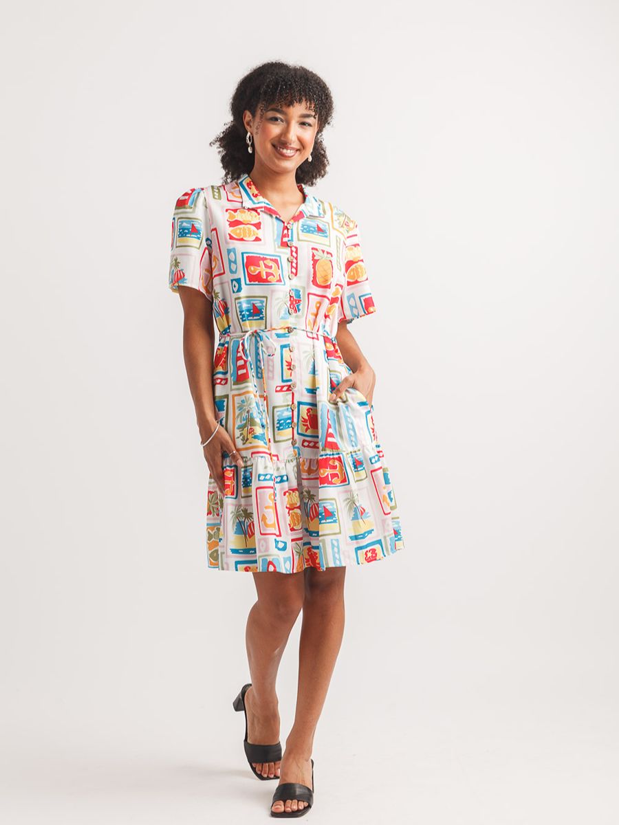 Short-sleeve collared dress with colorful geometric and floral print, paired with black open-toe heels.