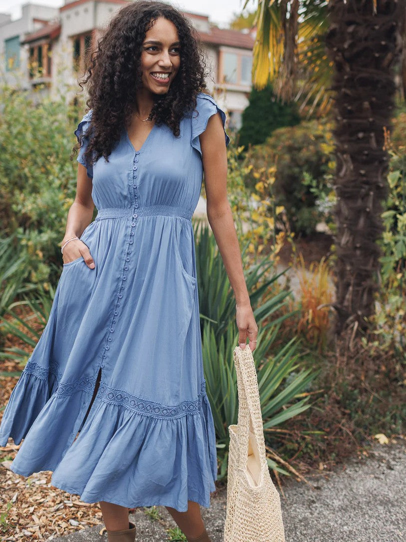 Blue Papillon Solid Button Front Midi Dress by Papillon with flutter sleeves and front pockets in outdoor garden setting