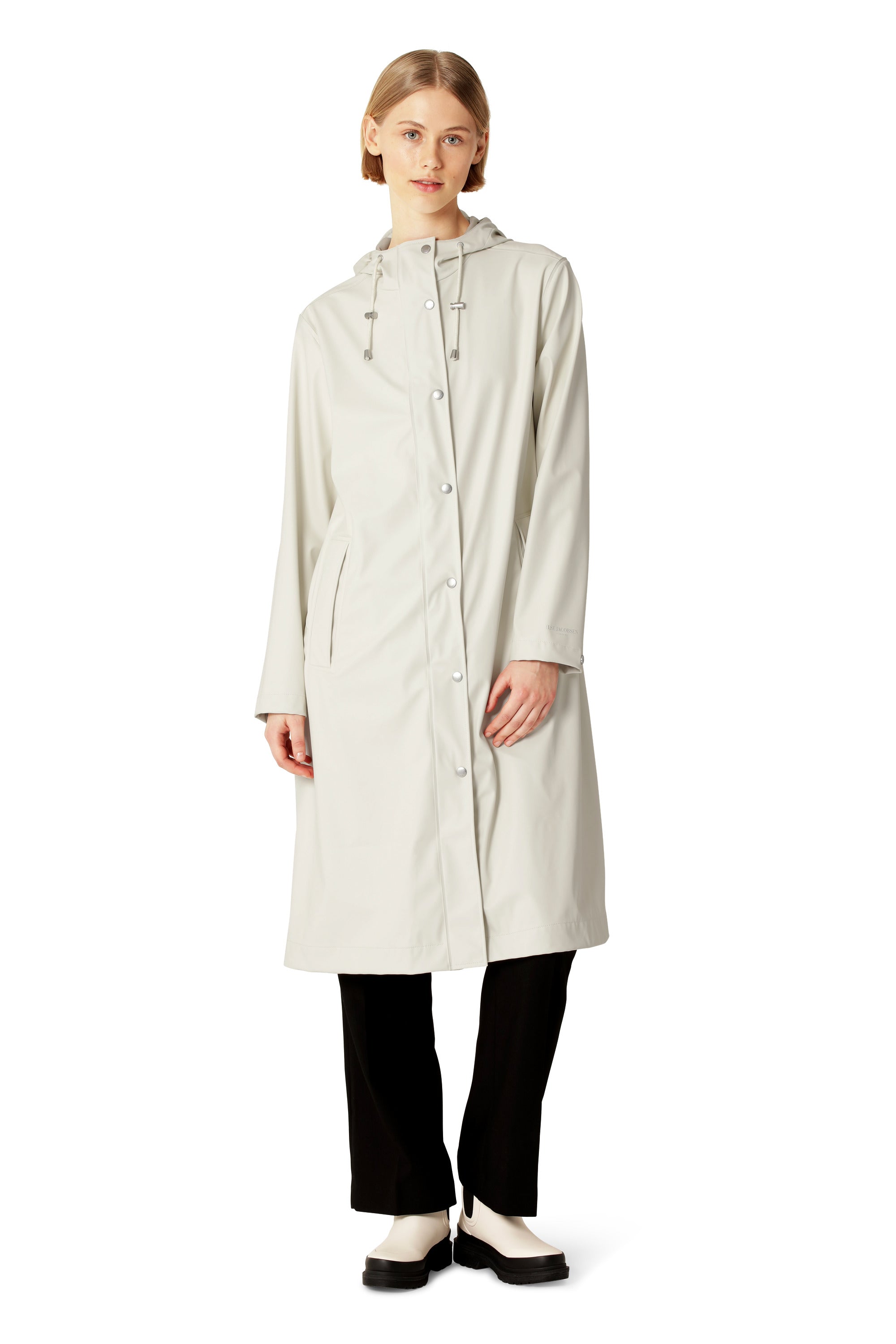 Ilse Jacobsen Long Waterproof Snap Hood Coat in cream, styled with black pants and light boots, outerwear fashion.