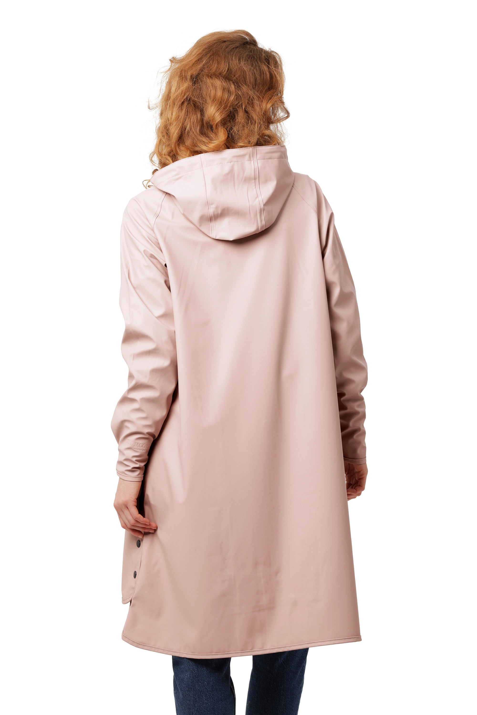 Back view of a pink Ilse Jacobsen Waterproof Snap Hood Rain Jacket worn over jeans, showcasing outerwear design.
