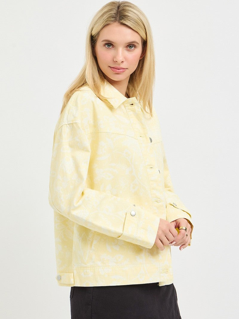 Light yellow Floral Print Denim Jacket by Risen with subtle floral patterns and buttoned cuffs, styled as outerwear.