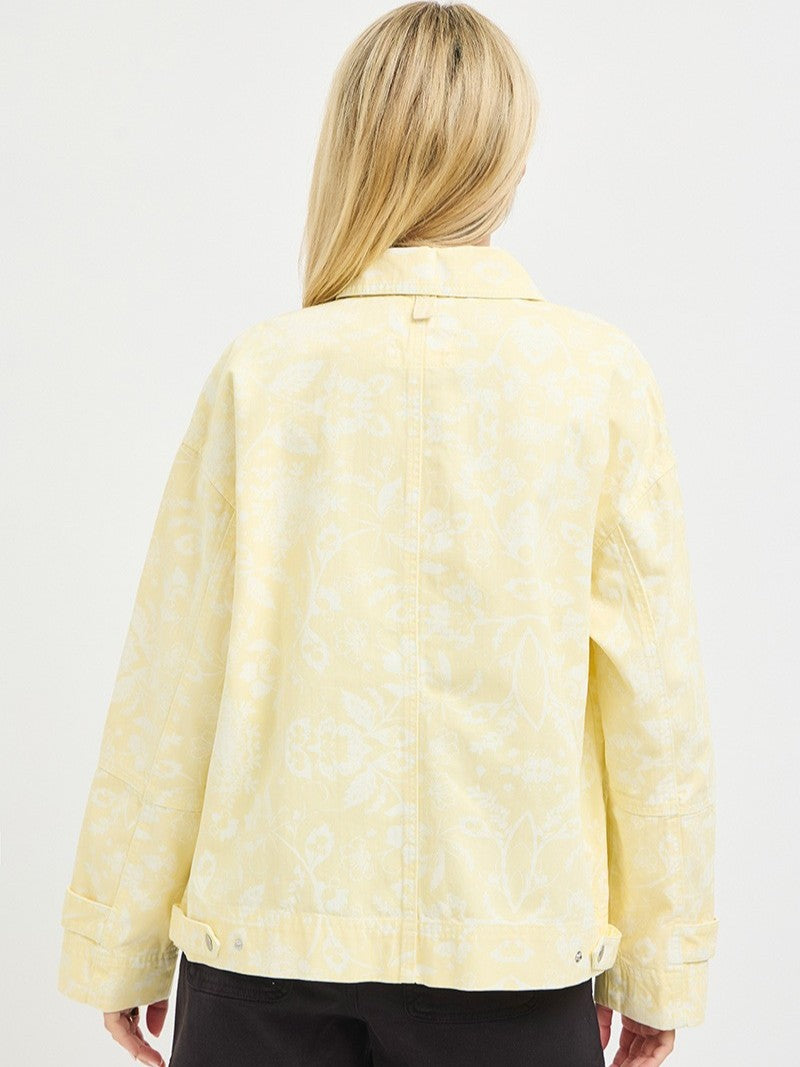 Light yellow denim jacket with subtle floral patterns shown from the back on a plain background.