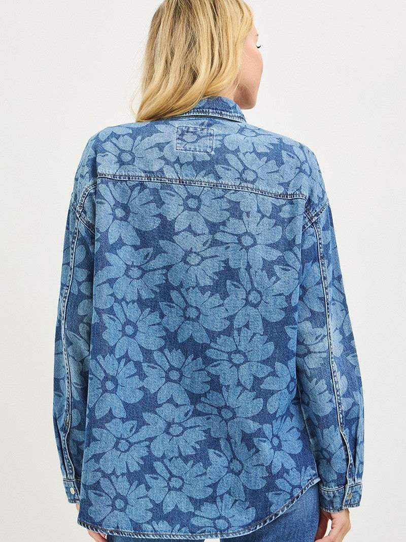 Denim jacket with an all-over large floral pattern in varying shades of blue on the back and sleeves.