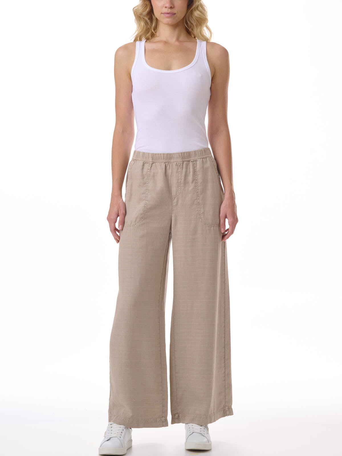 Splendid Angie Linen Blend Palazzo Pant in beige paired with white tank top and white sneakers by Splendid
