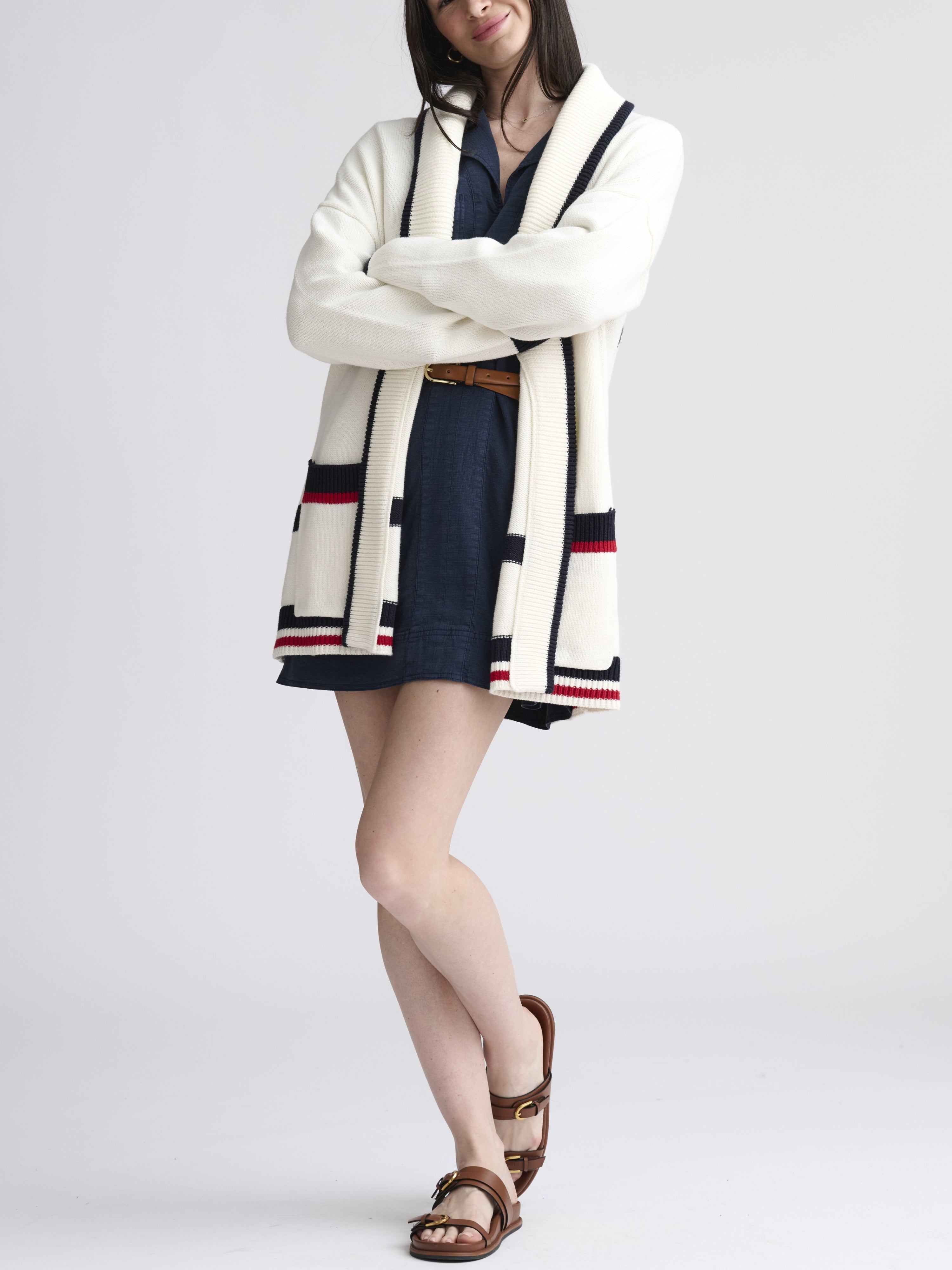 Splendid Set Sail Nautical Cardigan in white with navy and red trim, styled over a navy dress with sandals by Splendid.