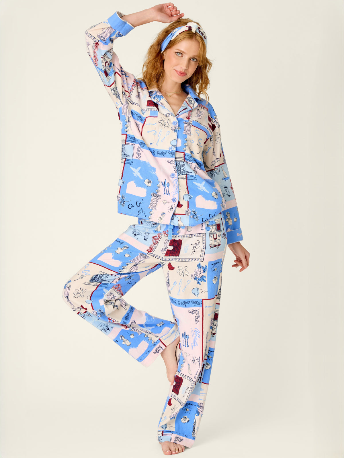 Fashion model in a blue and white illustrated matching shirt and pants with a patterned headband