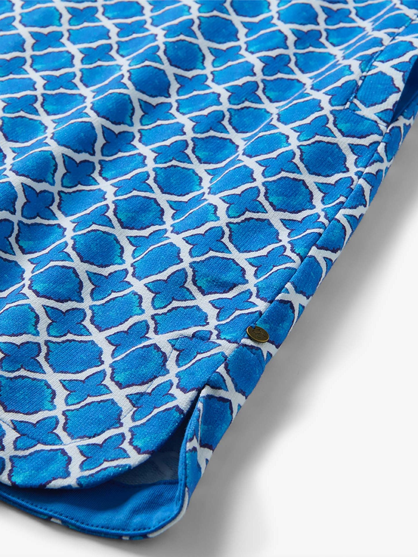 Close-up of blue patterned fabric detail on Hatley Capri French Dress by Hatley with a small metallic accent button