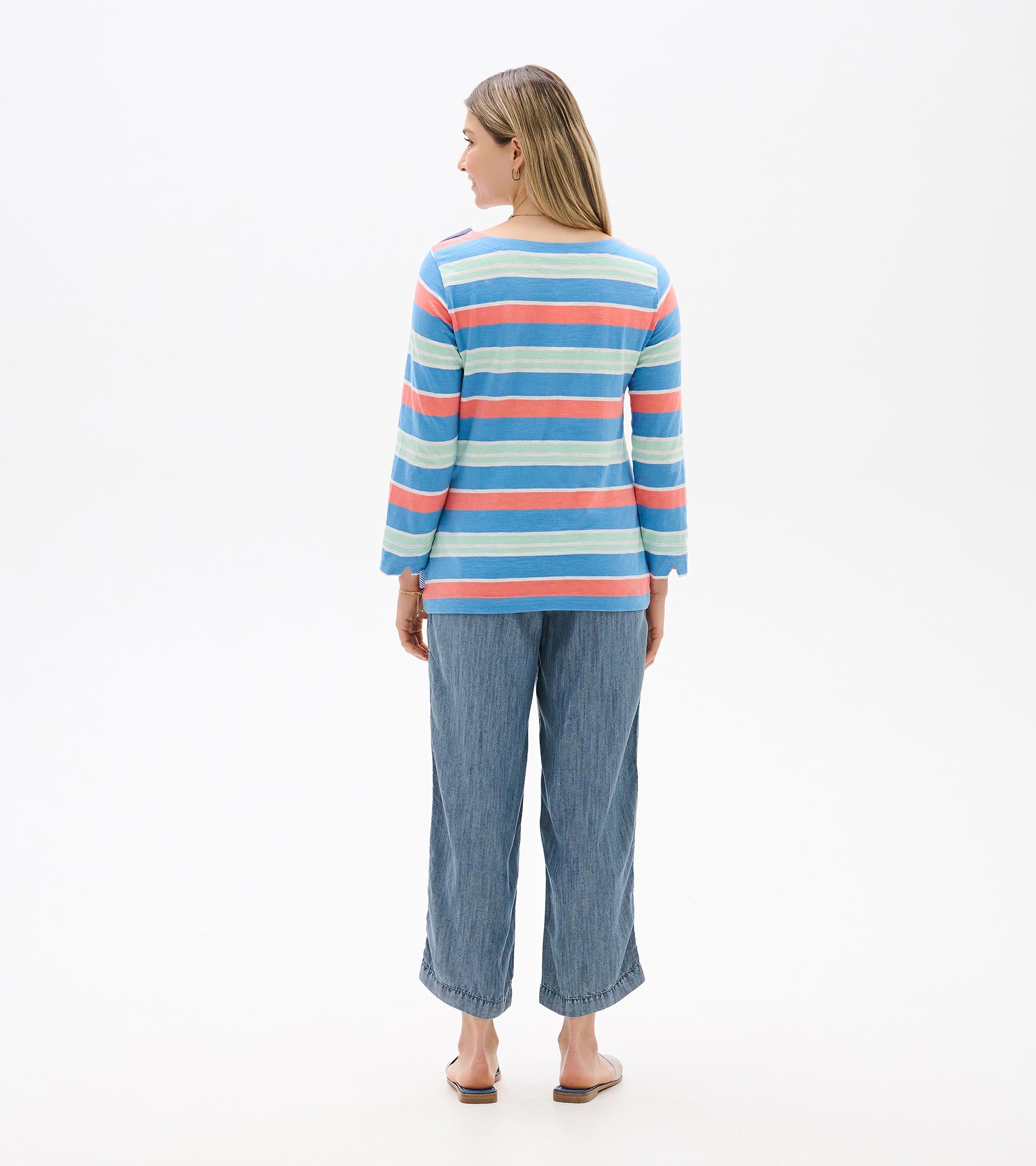 Back view of Hatley Breton Long Sleeve Top in blue, coral, and light stripes paired with denim pants by Hatley.