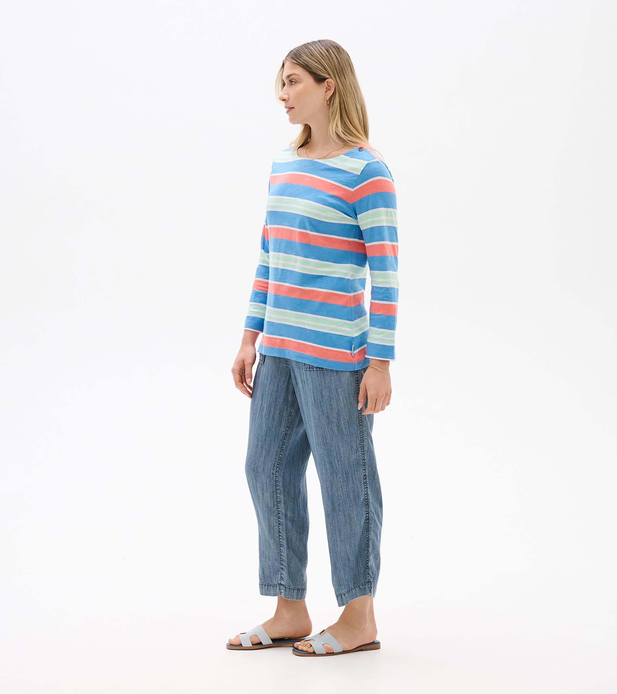 Hatley Breton Long Sleeve Top in pastel blue, coral, and white stripes paired with casual denim pants by Hatley