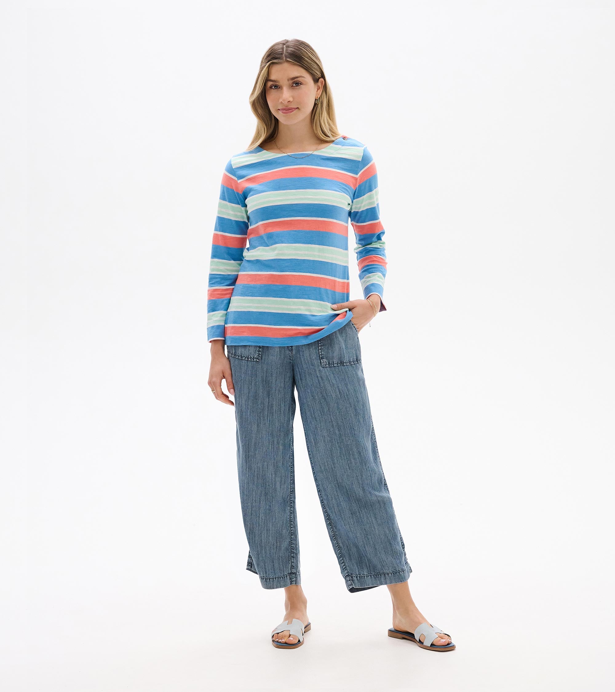 Hatley Breton Long Sleeve Top in blue, coral, and cream stripes paired with denim wide-leg pants from Hatley.