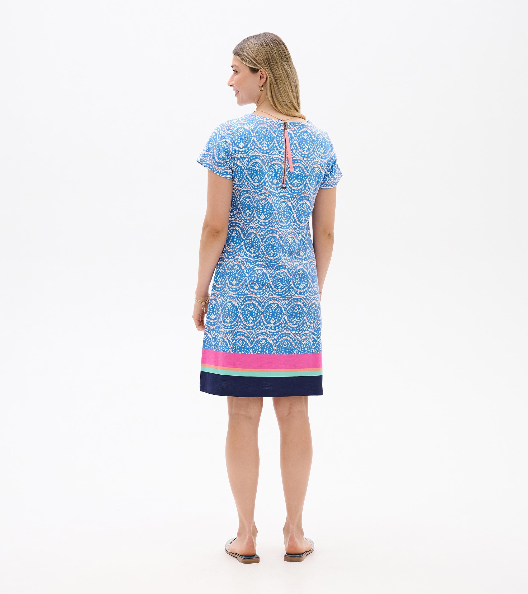 Back view of Hatley New Nellie Dress in blue patterned fabric with pink and navy hem, by Hatley.