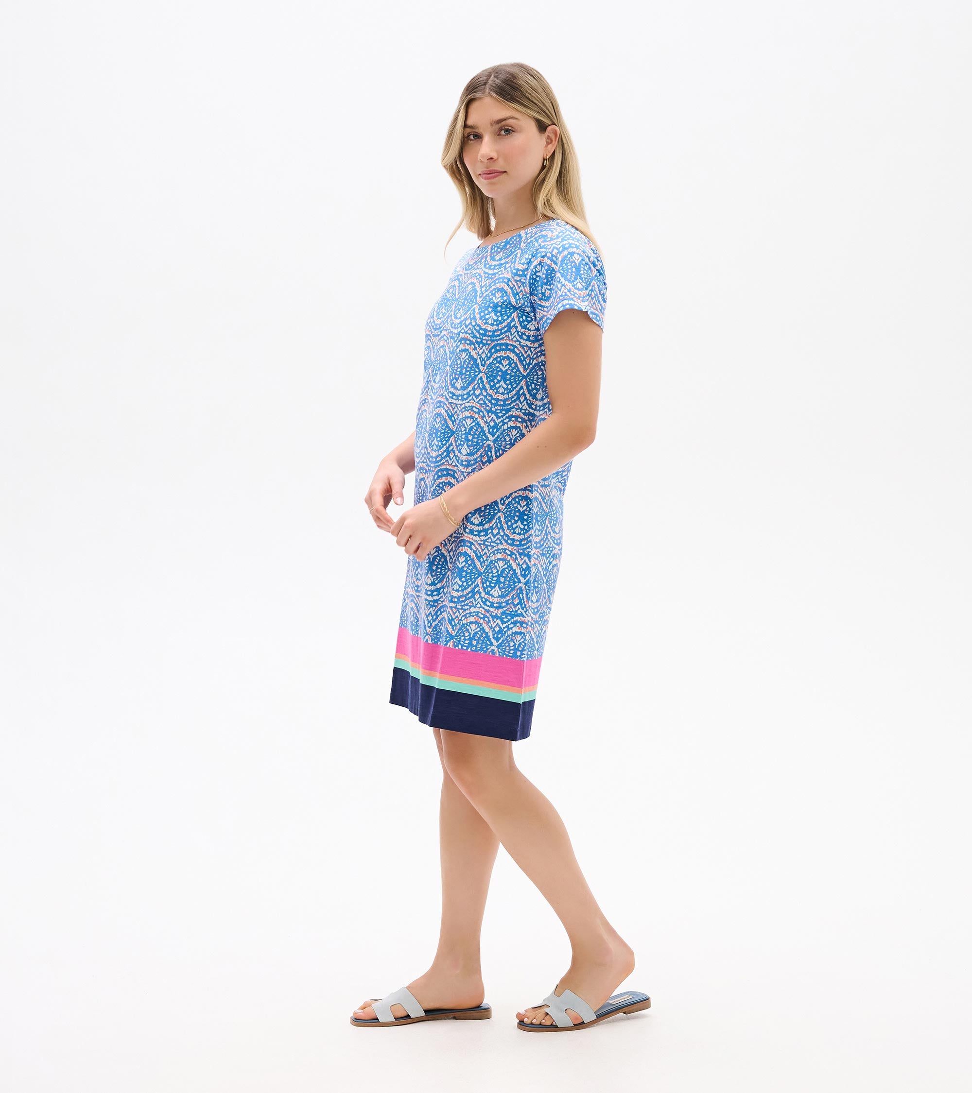 Blue patterned short-sleeve Hatley New Nellie Dress with pink and navy border, styled with white sandals