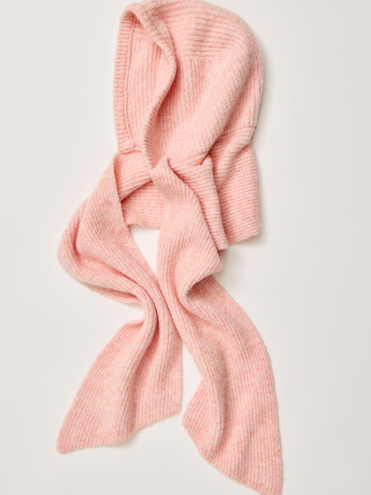 Pink knitted hooded scarf on a light background